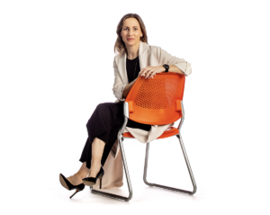 stollery researcher kate storey portrait sitting on chair on white background