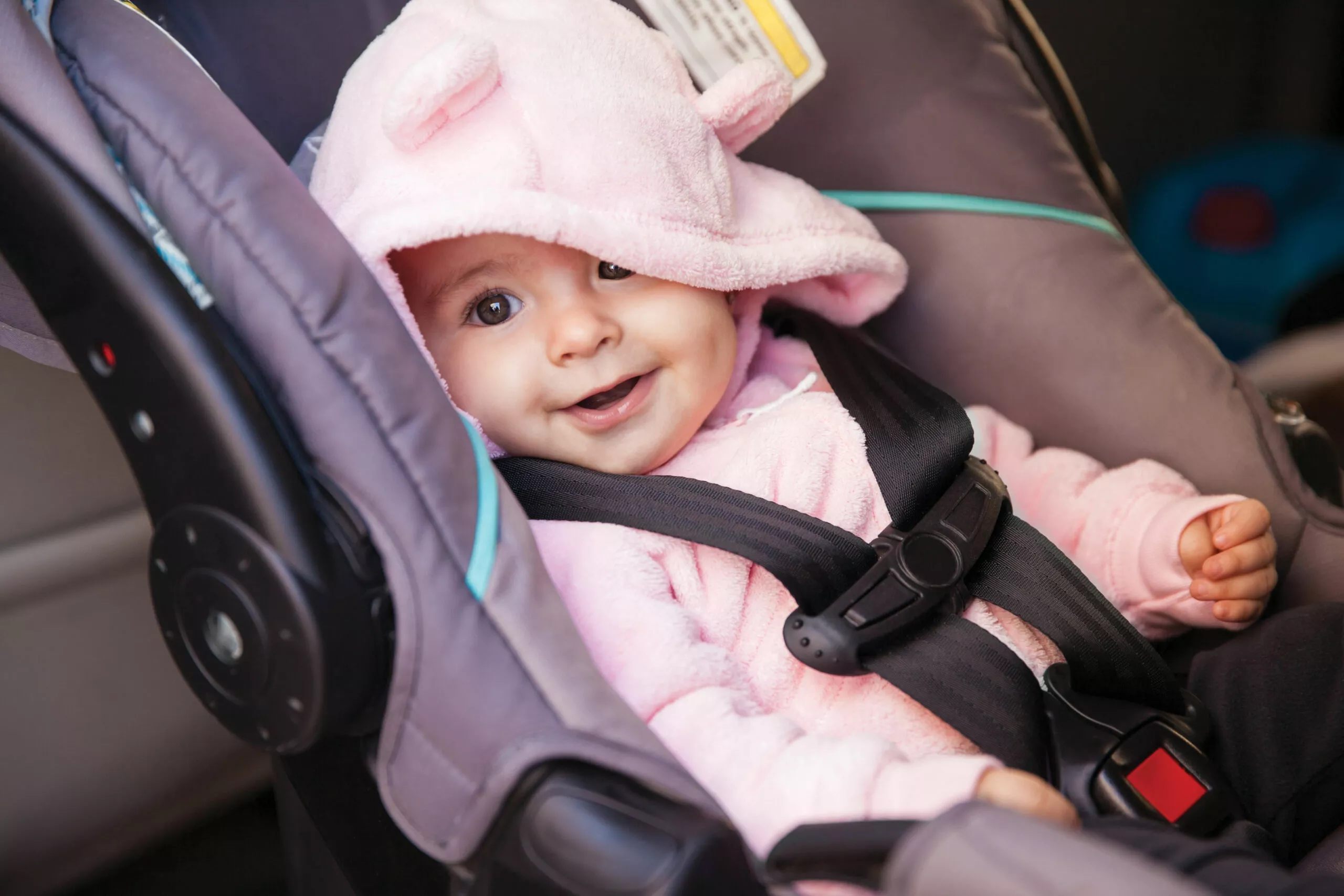 baby in car seat smiling