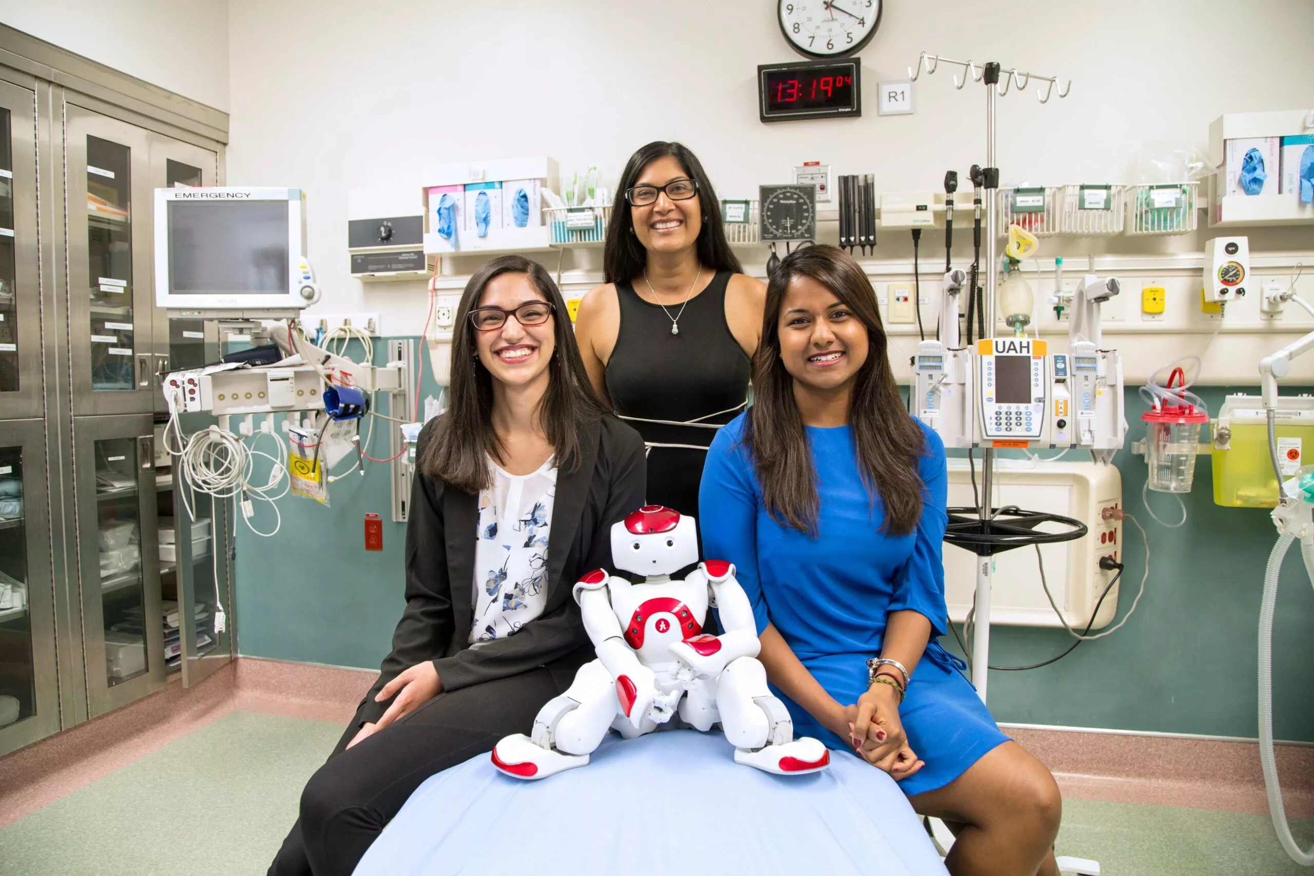 stollery staff medi team sitting on hospital bed with robot
