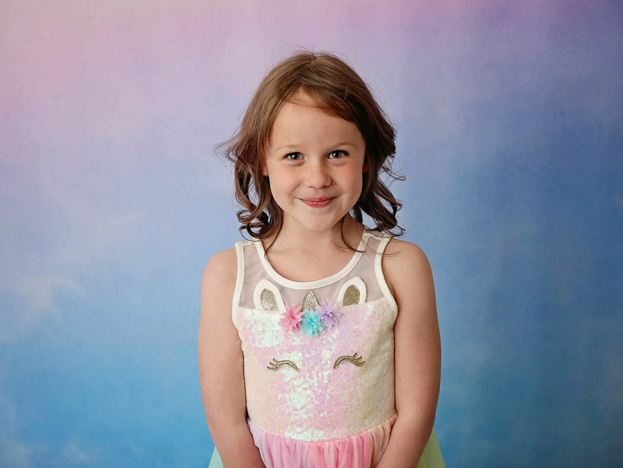 stollery kid emmy in unicorn dress with colourful background