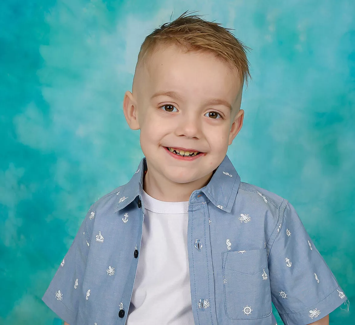 2023-stollery-kid-khai-smiling-blue-background