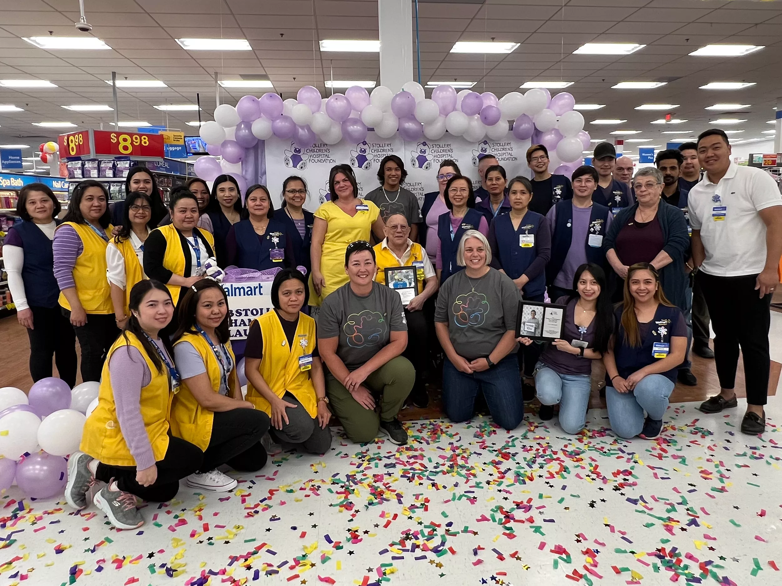 2023 Stollery Champion Elijah with employees from Walmart in Yellowknife (group photo).