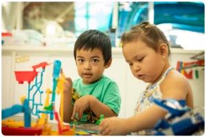 two young Stollery patients playing at the Saville Family Beach play area